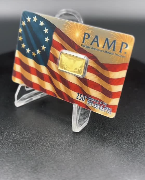 PAMP Suisse 250th Anniversary 2.5 g pure gold bar in American flag assay card on display stand